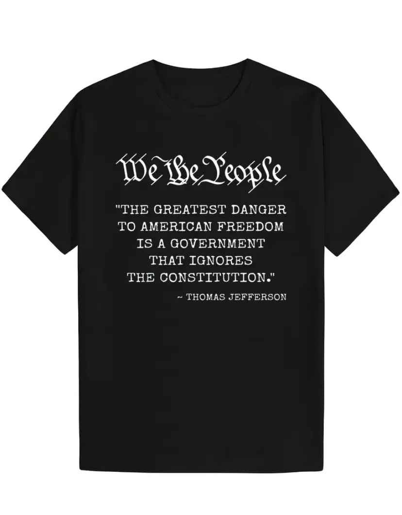 “We The People” “The Greatest Threat To American Freedom…” quote by Thomas Jefferson in white lettering on a Black T-Shirt