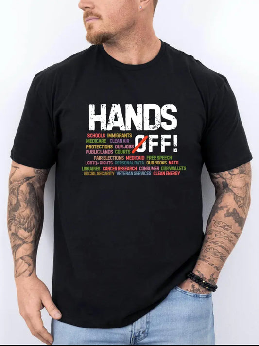 A person wearing a black T-shirt with 'HANDS OFF!' text and a list of issues separated by commas, printed on the front.