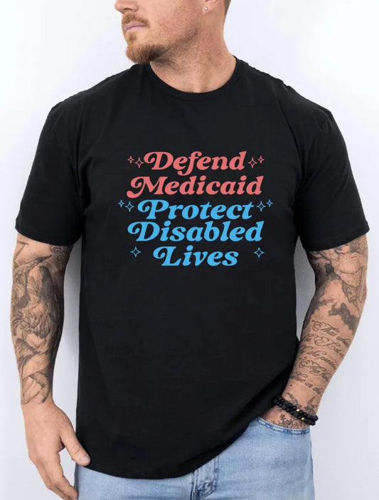 A person wearing a black t-shirt with the text 'Defend Medicaid Protect Disabled Lives' printed on the front.