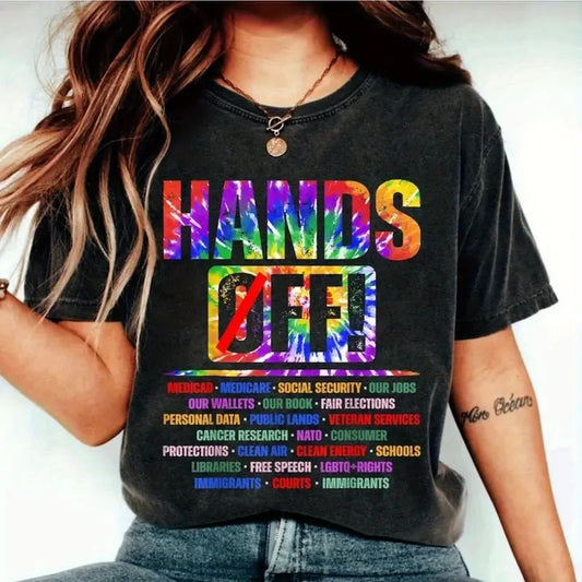Person wearing a black t-shirt with colorful text and symbols.